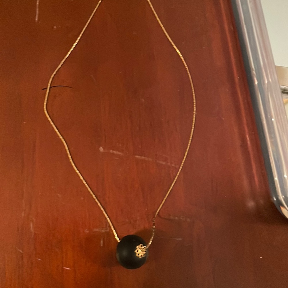 Gold necklace with black sphere